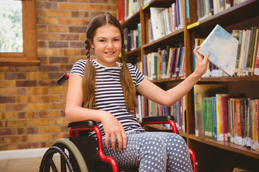 Girl in wheelchair selecting book iStock_000065035689_Small