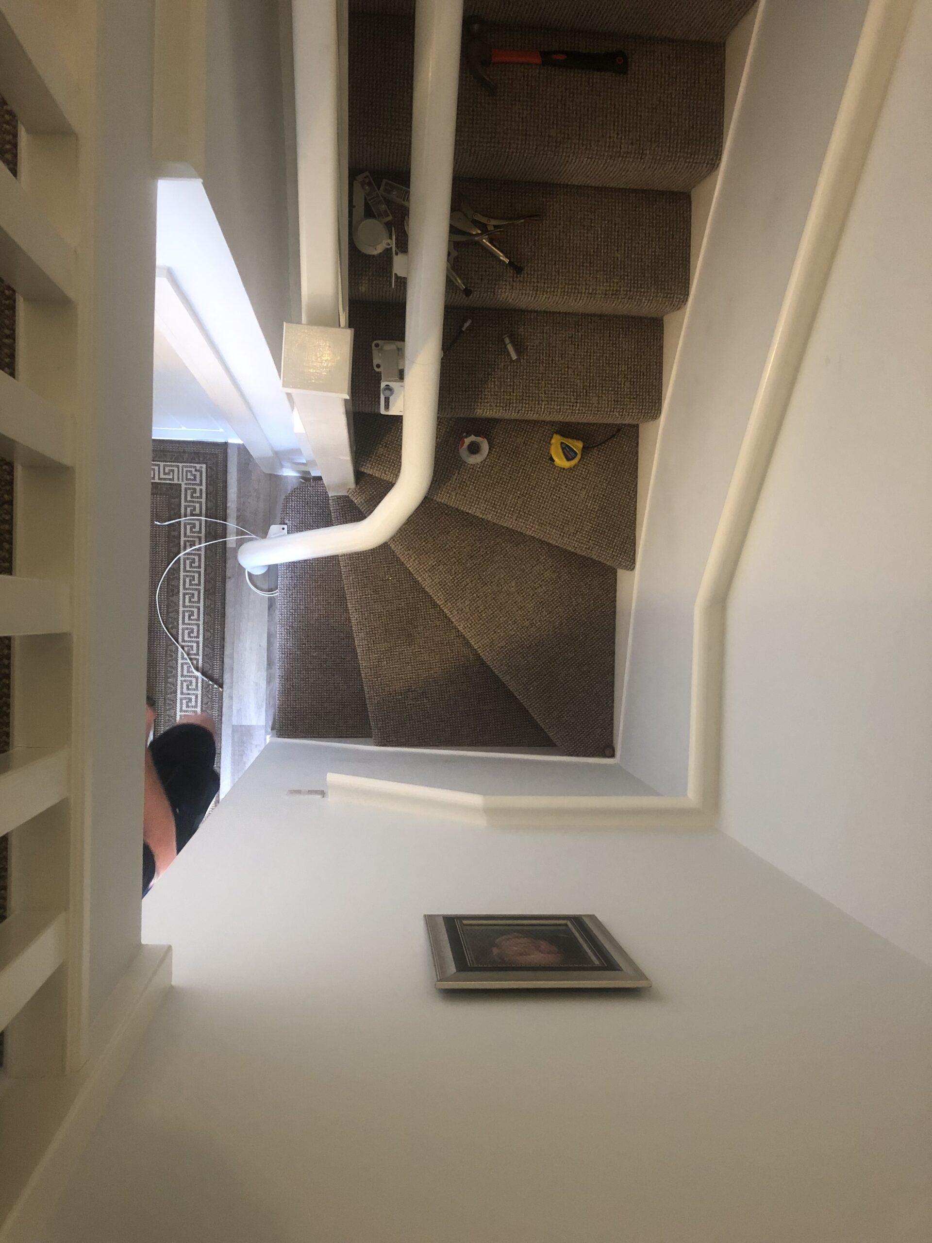 stairlift rail on a narrow staircase