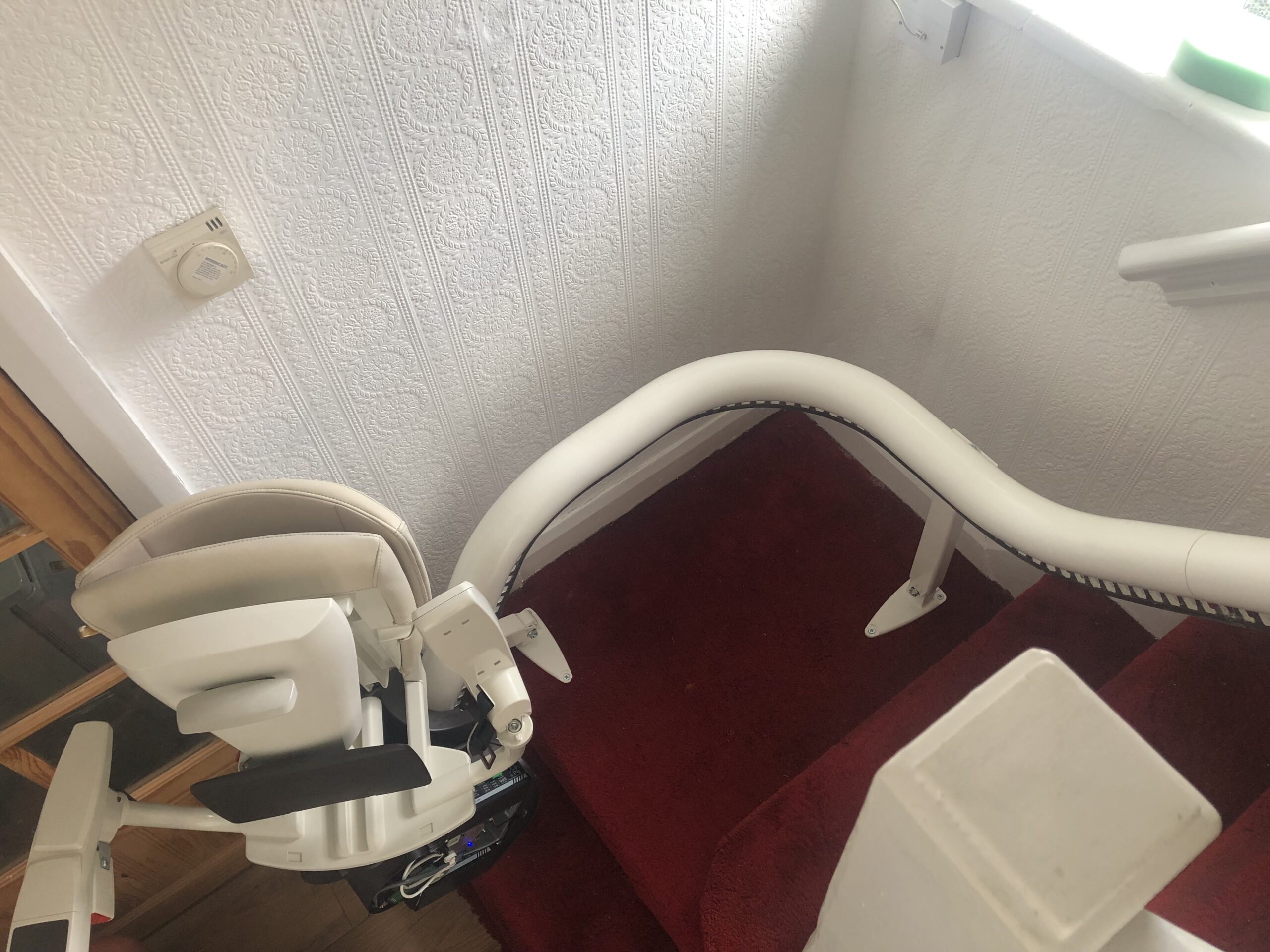 stairlift fitting on narrow staircase with awkward doorway