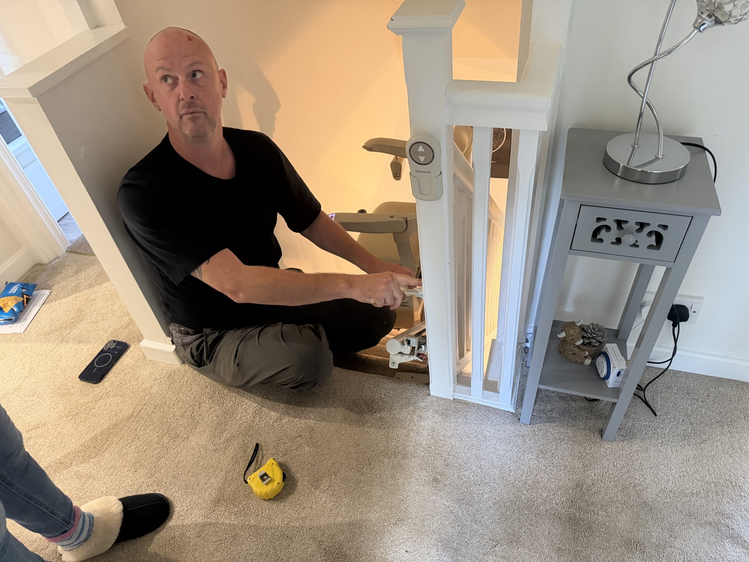 a stairlift engineer discussing a stairlift adaptation with a customer